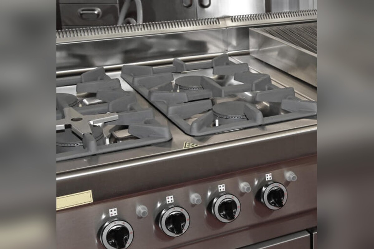 Burner grates and control knobs on a free-standing cooking range